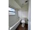 Bright bathroom with a white tiled shower and a soaking tub under a window at 3006 S Semoran Blvd # 7, Orlando, FL 32822