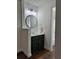 This bathroom has a new vanity, modern lighting and fixtures, and a round mirror at 3006 S Semoran Blvd # 7, Orlando, FL 32822