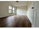 This bedroom has wood floors and natural light from a large window at 3006 S Semoran Blvd # 7, Orlando, FL 32822