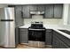 Modern kitchen featuring stainless steel appliances, gray cabinetry, and white countertops at 3006 S Semoran Blvd # 7, Orlando, FL 32822