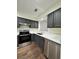 Bright kitchen featuring stainless steel appliances, white countertops, and gray cabinets at 3006 S Semoran Blvd # 7, Orlando, FL 32822