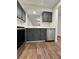 Kitchen featuring stainless steel appliances, sleek gray cabinets, and wood-look flooring at 3006 S Semoran Blvd # 7, Orlando, FL 32822
