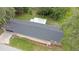 An aerial view showcasing the home's roof and backyard, surrounded by lush greenery and mature trees at 3207 Cr 419, Lake Panasoffkee, FL 33538