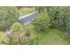 Aerial view of the landscaped property highlighting the home's backyard, mature trees, and outdoor space at 3207 Cr 419, Lake Panasoffkee, FL 33538