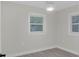 Bright bedroom featuring light gray floors, white trim, and neutral walls at 3207 Cr 419, Lake Panasoffkee, FL 33538