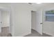 Bright bedroom featuring light gray floors, white trim, and modern doors at 3207 Cr 419, Lake Panasoffkee, FL 33538
