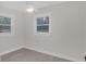 Bright bedroom with laminate floors, white trim, and modern ceiling fan at 3207 Cr 419, Lake Panasoffkee, FL 33538