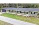 Charming single-story home with a well-maintained lawn and a dark grey attached garage at 3207 Cr 419, Lake Panasoffkee, FL 33538