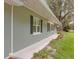 Side view of home with decorative shutters and sidewalk leading to front door at 3207 Cr 419, Lake Panasoffkee, FL 33538