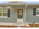 Front entrance with decorated front door, brick details and green shrubs at 3207 Cr 419, Lake Panasoffkee, FL 33538