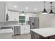 Bright kitchen featuring stainless steel appliances, white cabinetry, and modern pendant lights at 3207 Cr 419, Lake Panasoffkee, FL 33538