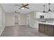 Open-concept kitchen and living area featuring stylish flooring, modern appliances, and white cabinetry at 3207 Cr 419, Lake Panasoffkee, FL 33538