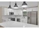 Well-lit kitchen featuring stainless steel appliances, sleek countertops and white cabinets at 3207 Cr 419, Lake Panasoffkee, FL 33538