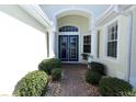 Inviting front entrance featuring a double door entry and manicured landscaping, creating a warm welcome at 255 Royal Palm Dr, Davenport, FL 33837