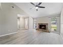 Spacious living room with a stone fireplace and neutral colors to match any style at 3240 Flamingo Ln, Mulberry, FL 33860