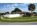 Tan house with red roof, white fence, and palm tree at 11432 Cardiff Dr, Orlando, FL 32837