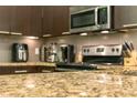 Close-up on granite countertops and stainless steel appliances in the modern kitchen at 17531 Placidity Ave, Clermont, FL 34714
