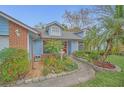 Inviting single-story home with a landscaped garden featuring a water feature and stone pathway at 8847 Rose Hill Dr, Orlando, FL 32818
