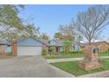 Charming single-story home with a well-manicured lawn, landscaped garden, and attached garage at 8847 Rose Hill Dr, Orlando, FL 32818