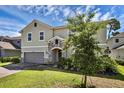 Beautiful home featuring stone accents, a well-manicured lawn, and a two-car garage in a desirable neighborhood at 29912 Cypress Pointe, Deer Island, FL 32778