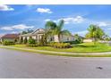 Well-maintained single-story home showcasing lush landscaping, mature trees, and a manicured lawn on a sunny day at 1532 Eagle Ridge Dr, Lakeland, FL 33813