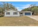 Newly renovated home with blue garage door and landscaped yard at 1228 Se 17Th St, Ocala, FL 34471