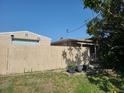 Exterior view of the home featuring a fenced yard and exterior storage area at 1505 N Peninsula Ave, New Smyrna Beach, FL 32169