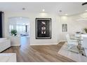 Modern dining room with glass table, white chairs, and geometric wall design at 2621 Lookout, Kissimmee, FL 34746