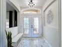 Bright entryway with elegant double doors and marble-look flooring at 2621 Lookout, Kissimmee, FL 34746