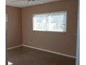 Bright bedroom featuring neutral walls, vintage floor, and a large window letting in natural light at 3110 Port Royal Dr, Orlando, FL 32827