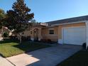 Ranch style home with a two-car garage and well-manicured lawn at 3110 Port Royal Dr, Orlando, FL 32827