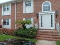 A front door entrance of a townhouse with brick steps and updated features at 4200 Lake Underhill Rd # A, Orlando, FL 32803