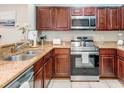 Well-equipped kitchen with stainless steel appliances and granite countertops offers ample cooking space at 1301 Tuscan Ter # 9401, Davenport, FL 33896