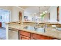 Open kitchen featuring granite countertops, stainless steel dishwasher, and a double stainless steel sink at 1301 Tuscan Ter # 9401, Davenport, FL 33896