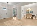 Inviting entryway featuring light hardwood floors, a dining room, a study, and a neutral-colored rug at 3022 Peel Ave, Orlando, FL 32806