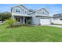 Beautiful two-story house with well-maintained green lawn and attractive landscaping, enhancing curb appeal at 3022 Peel Ave, Orlando, FL 32806