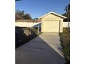 Detached garage with a large door and concrete driveway at 2814 Coventry Ave, Lakeland, FL 33803