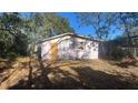 Block building in need of repair, located in a wooded area at 109 Hibiscus Ave, Davenport, FL 33837