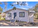 Charming house with white siding, gray door, and well-maintained landscaping at 1316 Hackett St, Mount Dora, FL 32757