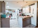 Bright kitchen with all-white appliances, painted cabinets, and an island counter at 8115 Esperanza St, Orlando, FL 32817