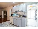 Kitchen with light grey cabinets and a view to backyard at 8115 Esperanza St, Orlando, FL 32817