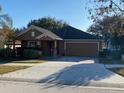 One-story house with attached garage and landscaped front yard at 124 Dakota Ave, Groveland, FL 34736