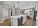 Modern kitchen island with white quartz countertop and stainless steel appliances at 688 Orange Belt Loop, Winter Garden, FL 34787