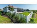 Landscaped backyard with white fence and patio at 7865 Sw 89Th Cir, Ocala, FL 34481