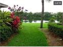 Peaceful backyard with a scenic lake view and lush landscaping at 4537 Ring Neck Rd # C, Orlando, FL 32808