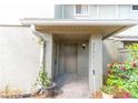 Condo entrance with a covered porch and blooming flowers at 4537 Ring Neck Rd # C, Orlando, FL 32808