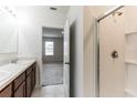 Double vanity bathroom with shower and access to bedroom at 125 Sunny Day Way, Davenport, FL 33897