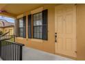 Front entrance with light-yellow door and black shutters at 4014 Sunburst View Cir, Kissimmee, FL 34746