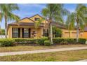 House exterior featuring a two-car garage and lush landscaping at 4014 Sunburst View Cir, Kissimmee, FL 34746
