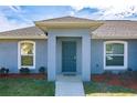 Inviting single-Gathering home features a covered entryway and well-maintained landscaping at 12854 Sw 77Th Cir, Ocala, FL 34473